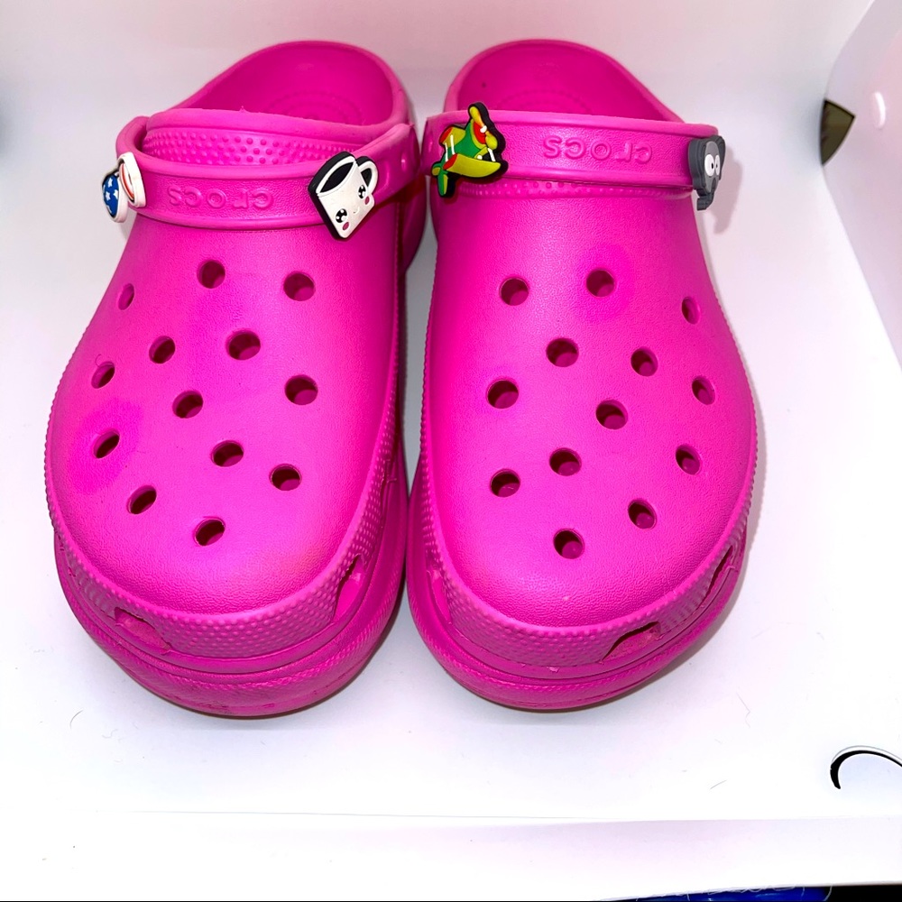 Pink platform crocs.